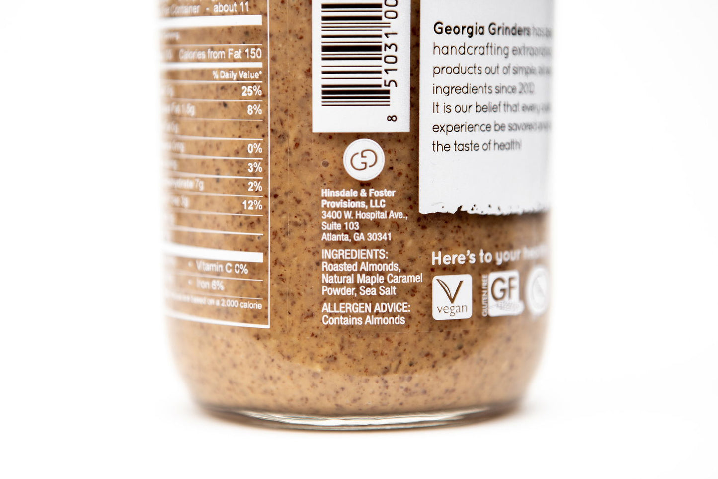 A close-up of Georgia Grinders Maple Caramel Almond Butter and Honey Roasted Almond Butter Mix Pack jars displays the ingredients—including California almonds, maple caramel powder, and sea salt—plus allergen info, nutrition facts, and vegan/gluten-free icons.
