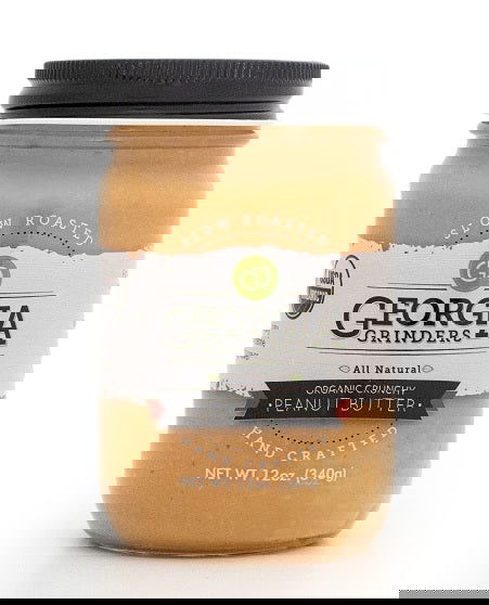 A 64oz bulk tub of Georgia Grinders Organic Crunchy Peanut Butter, labeled "All Natural," "USDA Organic Certified," and displaying the Georgia Grown brand, packed with chunky light brown peanut spread.