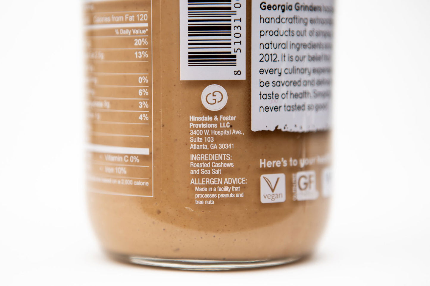 Close-up of a Georgia Grinders 12 oz WHOLE30 Nut Butter Assortment jar (Original Almond, Cashew, Pecan, Hazelnut), showing ingredients, allergy info, barcode, vegan & gluten-free symbols—ideal for Whole30.