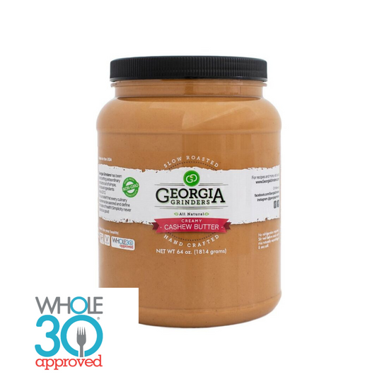 A 64 oz bulk tub of Georgia Grinders Cashew Butter (CP-CL) with a black lid and white label, showing Vegan Friendly and Whole30 Approved in blue and red text at the bottom left.