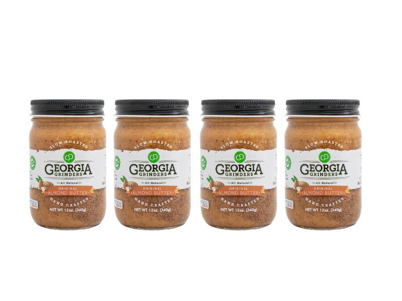 Four 12 oz jars of Georgia Grinders Original Almond Butter are arranged in a row with clear labels and black lids—ideal for those wanting Vegan Friendly or Keto Friendly options. Available as a 4 Pack by Georgia Grinders.