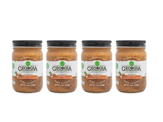 Four 12 oz jars of Georgia Grinders Original Almond Butter are arranged in a row with clear labels and black lids—ideal for those wanting Vegan Friendly or Keto Friendly options. Available as a 4 Pack by Georgia Grinders.