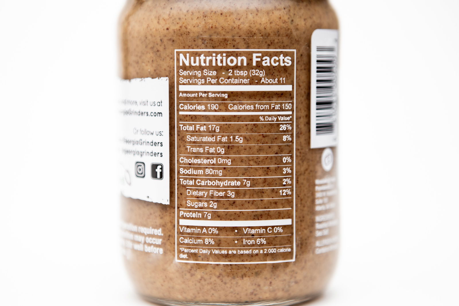 A close-up of Georgia Grinders Original Almond Butter 4 Pack (12 oz jars) by Georgia Grinders shows the Nutrition Facts label with serving size, calories, and nutrients in black on white. Keto and vegan friendly.