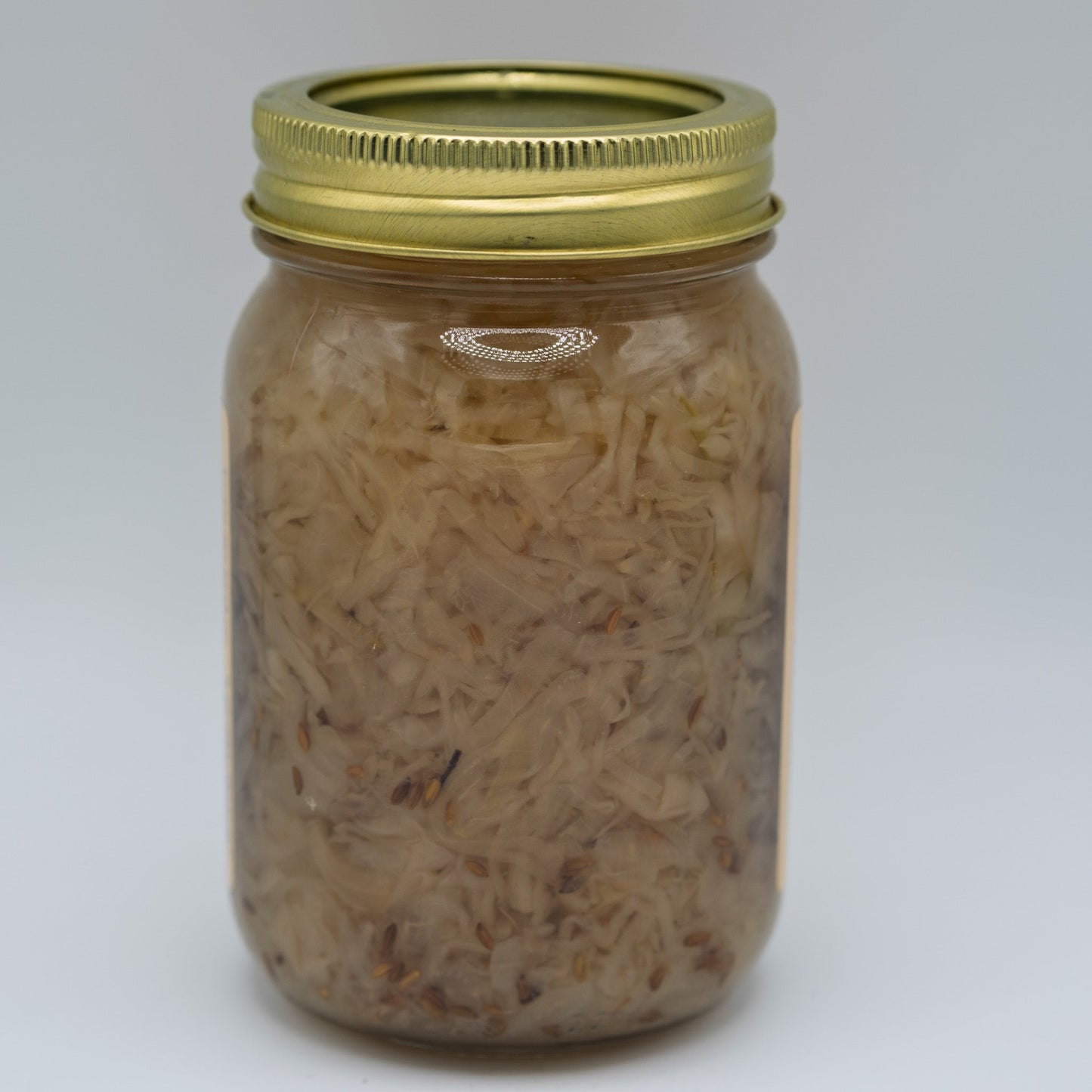 Canned German Sauerkraut from Amish Country Store, showing a jar of fermented cabbage with a label and lid.