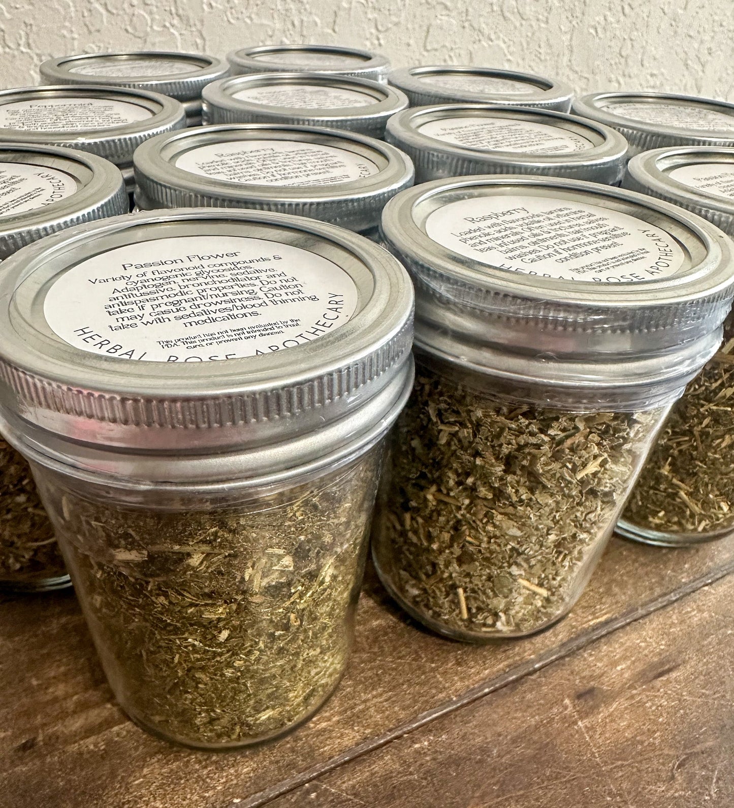 Small glass jars with dried herbs from HerbalRoseApothecary, showcasing herbal jars for storage and herbal remedies.
