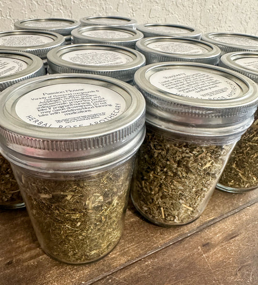 Small glass jars with dried herbs from HerbalRoseApothecary, showcasing herbal jars for storage and herbal remedies.