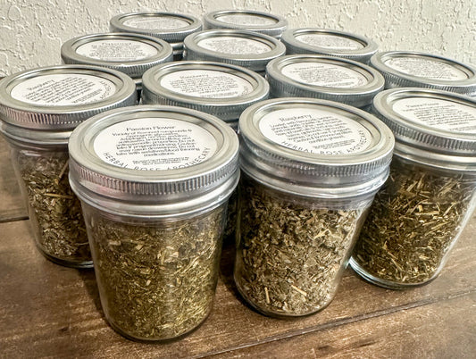 Set of small glass jars filled with dried herbs from HerbalRoseApothecary, ideal for herbal storage and apothecary use.