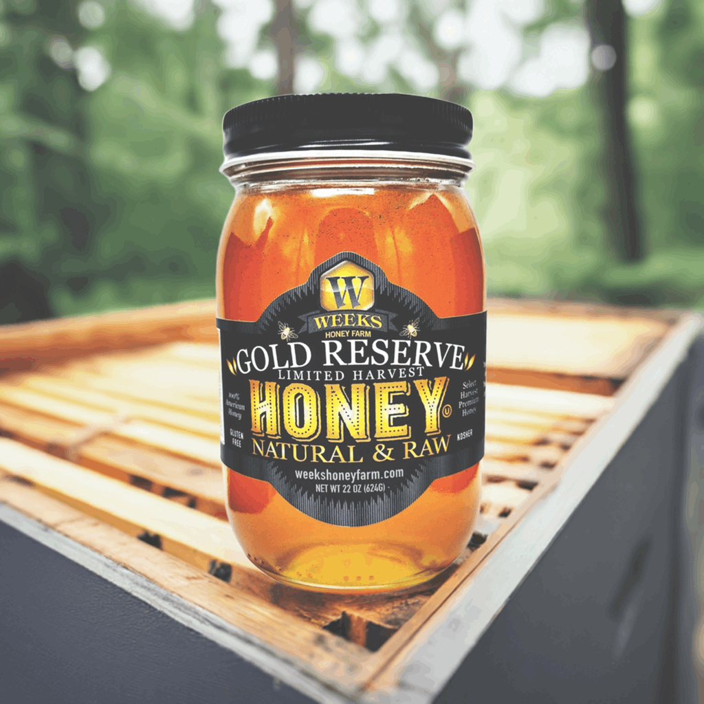 A glass jar of Weeks Honey Farm’s Raw Gold Reserve Honey, Special Edition—unfiltered natural honey from Georgia—rests on a beehive outdoors. The label notes it contains 22 ounces, with a soft green forest in the background.