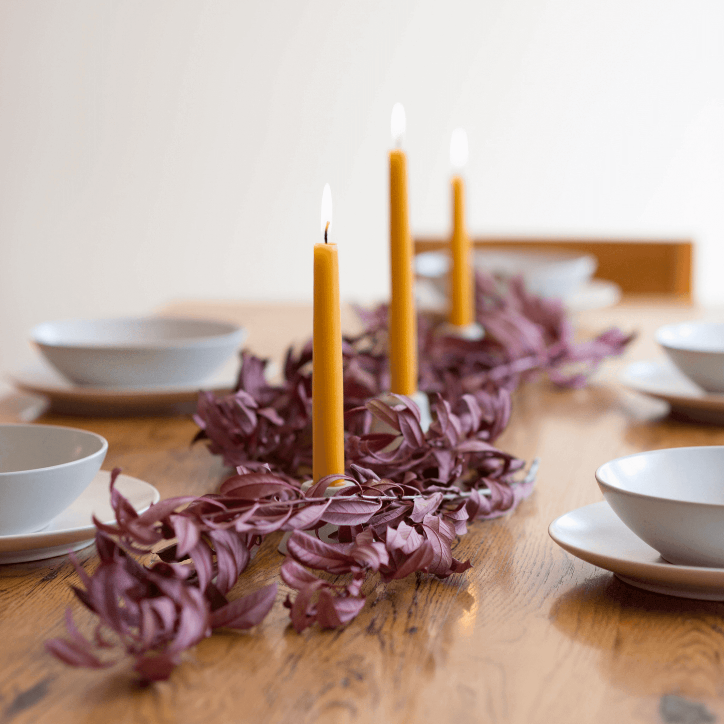 Hand-dipped beeswax taper candles in a bulk 4-pair bundle by Bluecorn Candles, shown with natural textured wax and wicks.