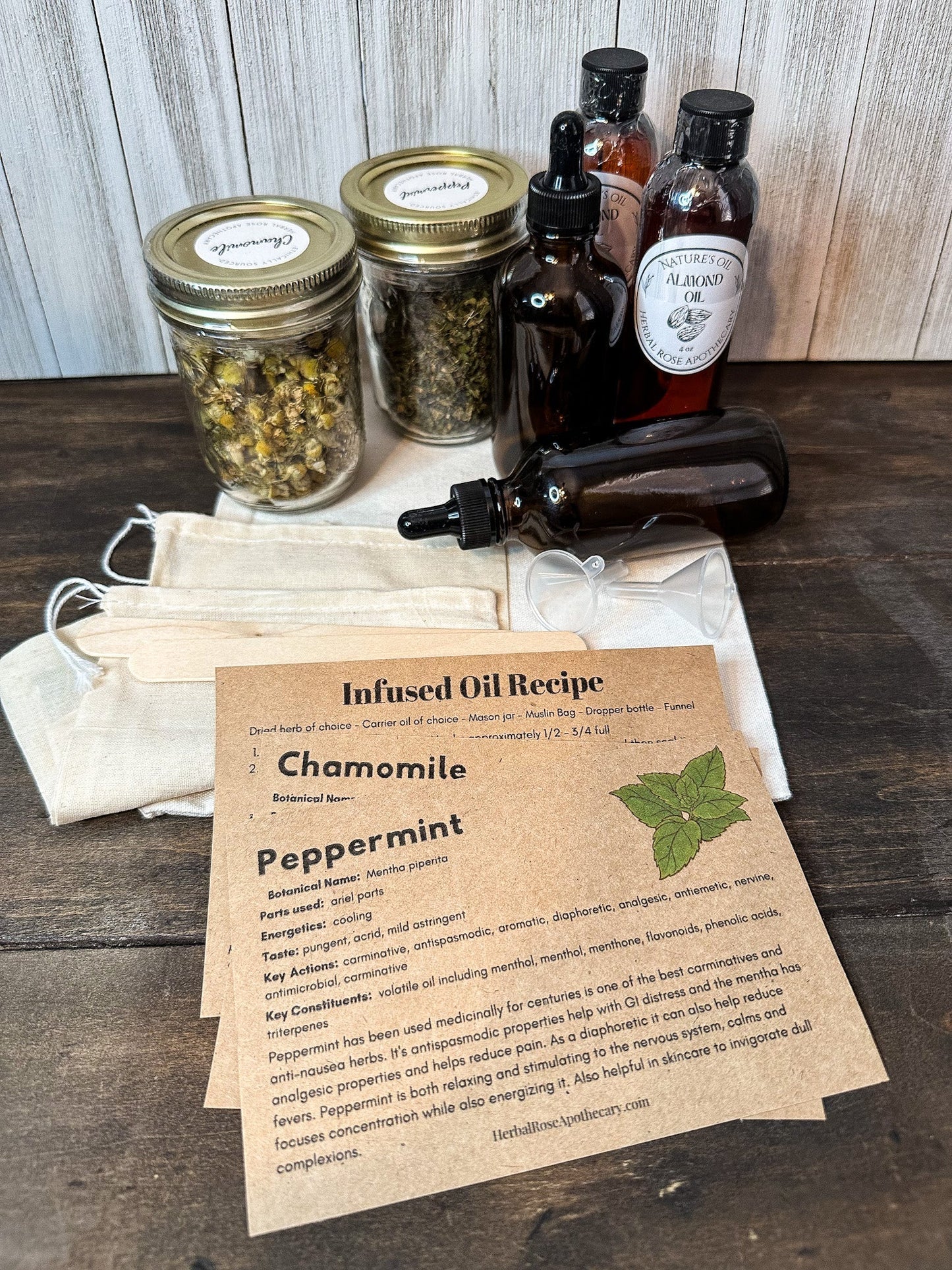 DIY herbal infused oil kit from HerbalRoseApothecary, featuring natural herbs and bottles for making herbal oils at home.