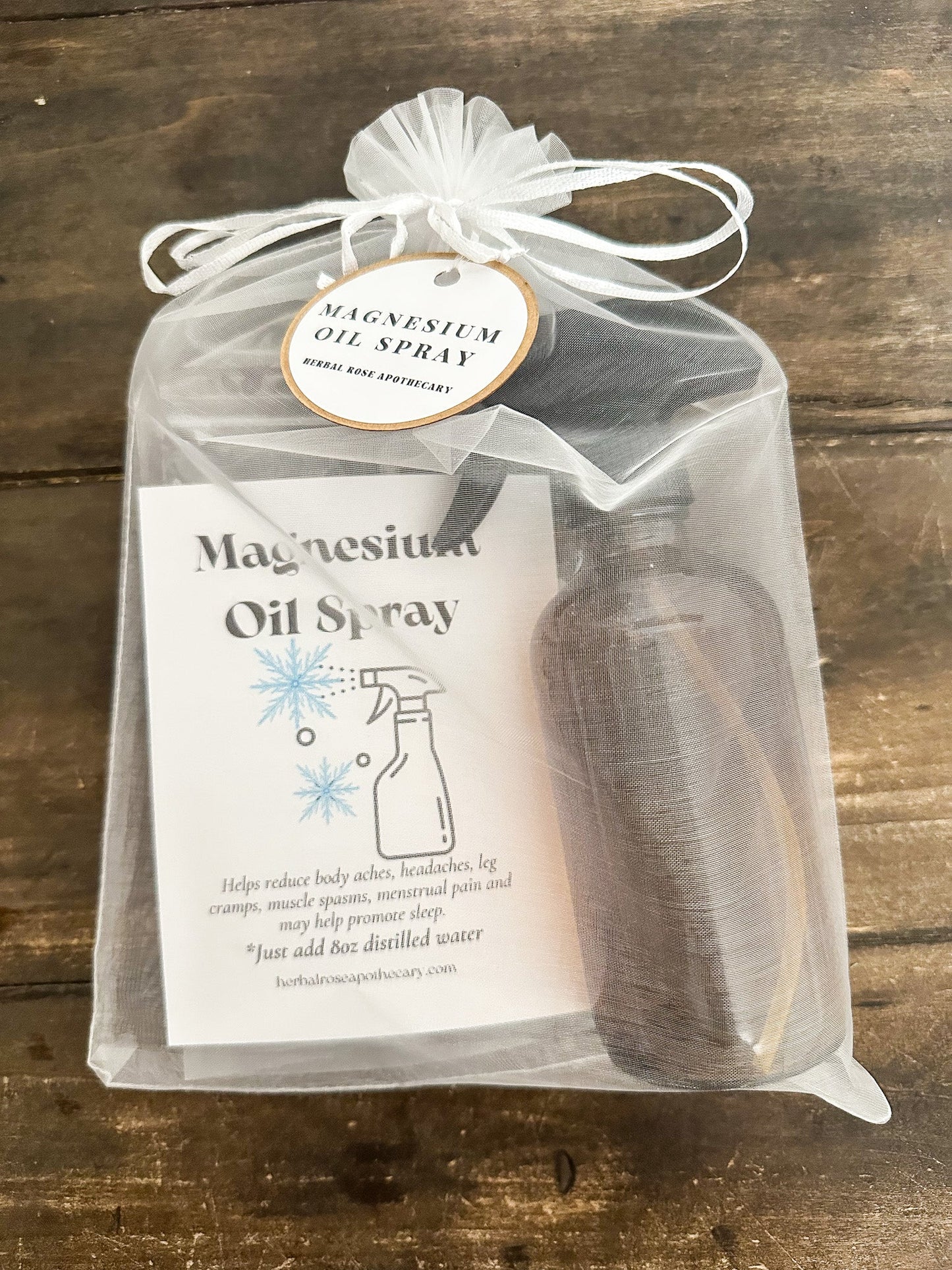 HerbalRoseApothecary DIY magnesium oil spray in a clear glass bottle, part of an apothecary kit for homemade wellness products.
