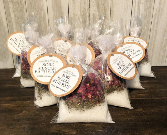 Herbalroseapothecary herbal bath soak with Epsom salt, peppermint, roses, and herbs for soothing sore muscles in a natural setting.