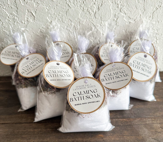 Herbalroseapothecary sore muscle bath soak with Epsom salts, peppermint, and herbs in a clear glass jar, ready for relaxing bath.