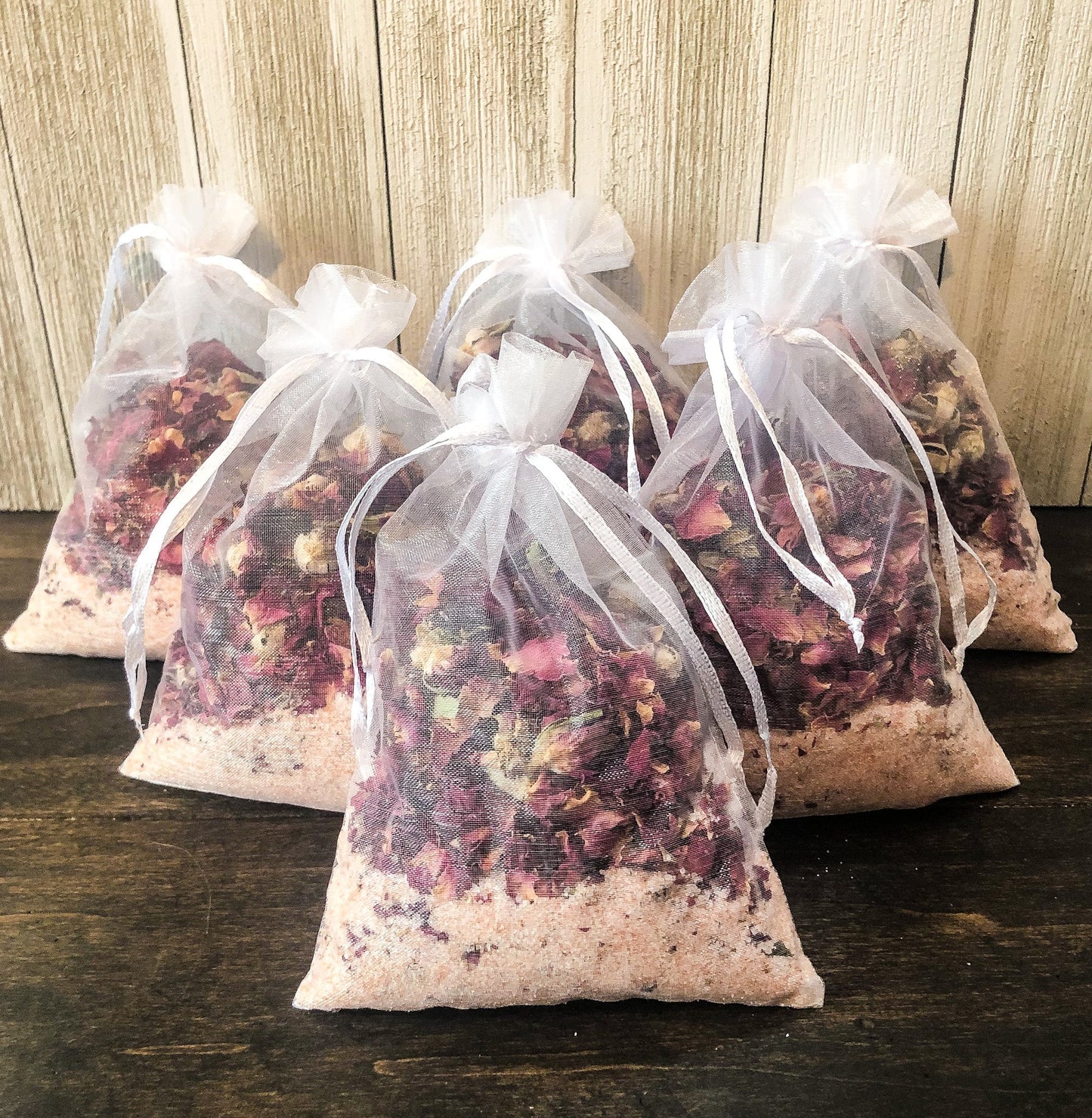 Herbalroseapothecary herbal bath soak with Epsom salt, peppermint, and dried herbs for sore muscles in a glass jar.