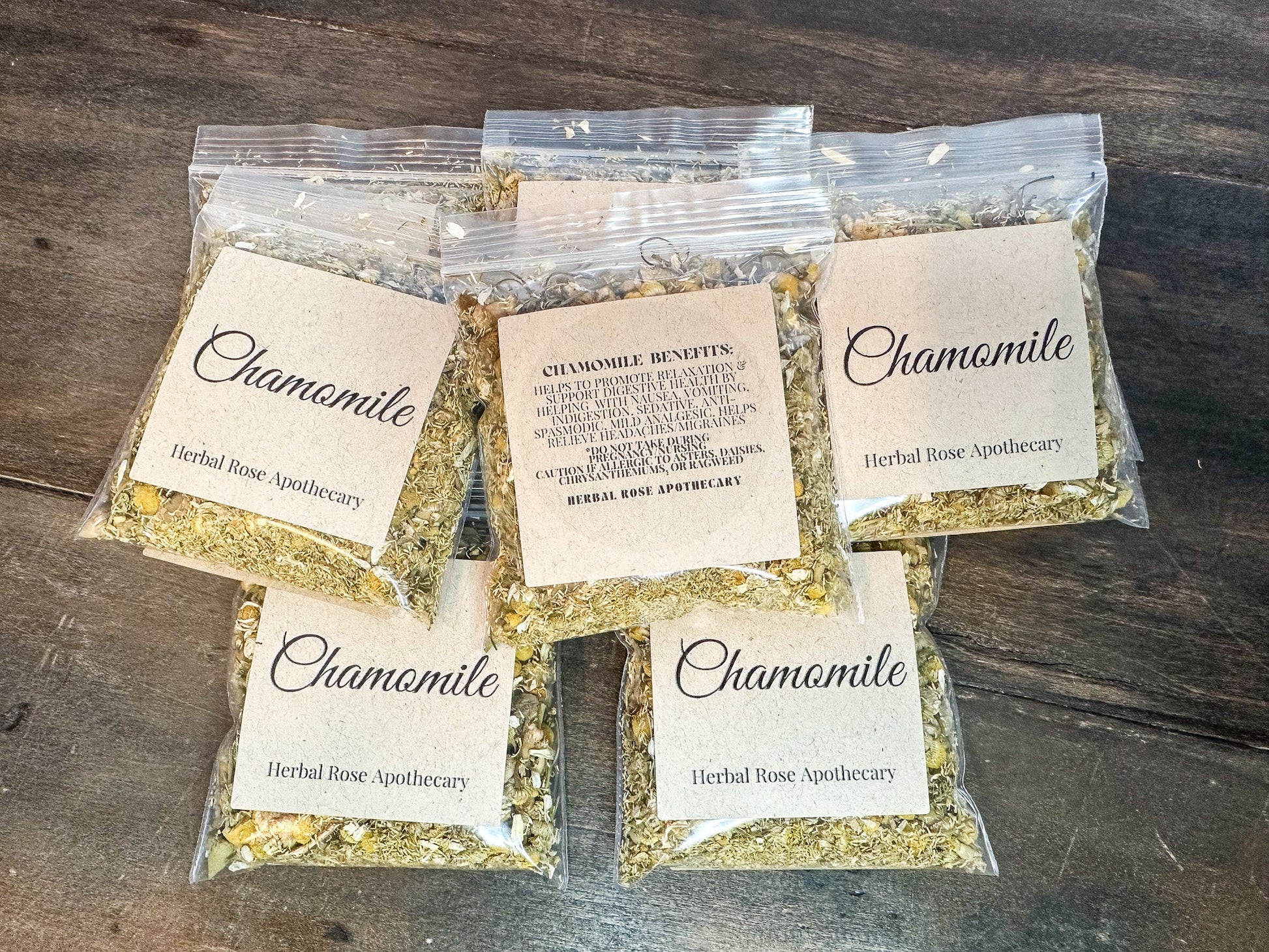 Dried organic chamomile herbs in an 8g package from HerbalRoseApothecary, showcasing fragrant, golden chamomile flowers.