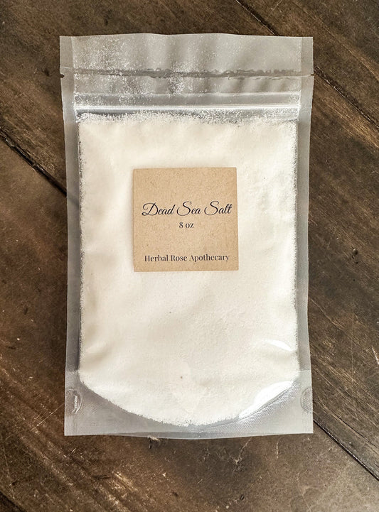 HerbalRoseApothecary Dead Sea Salt with oats in a clear jar, showcasing coarse textured salts and natural oats for skincare.