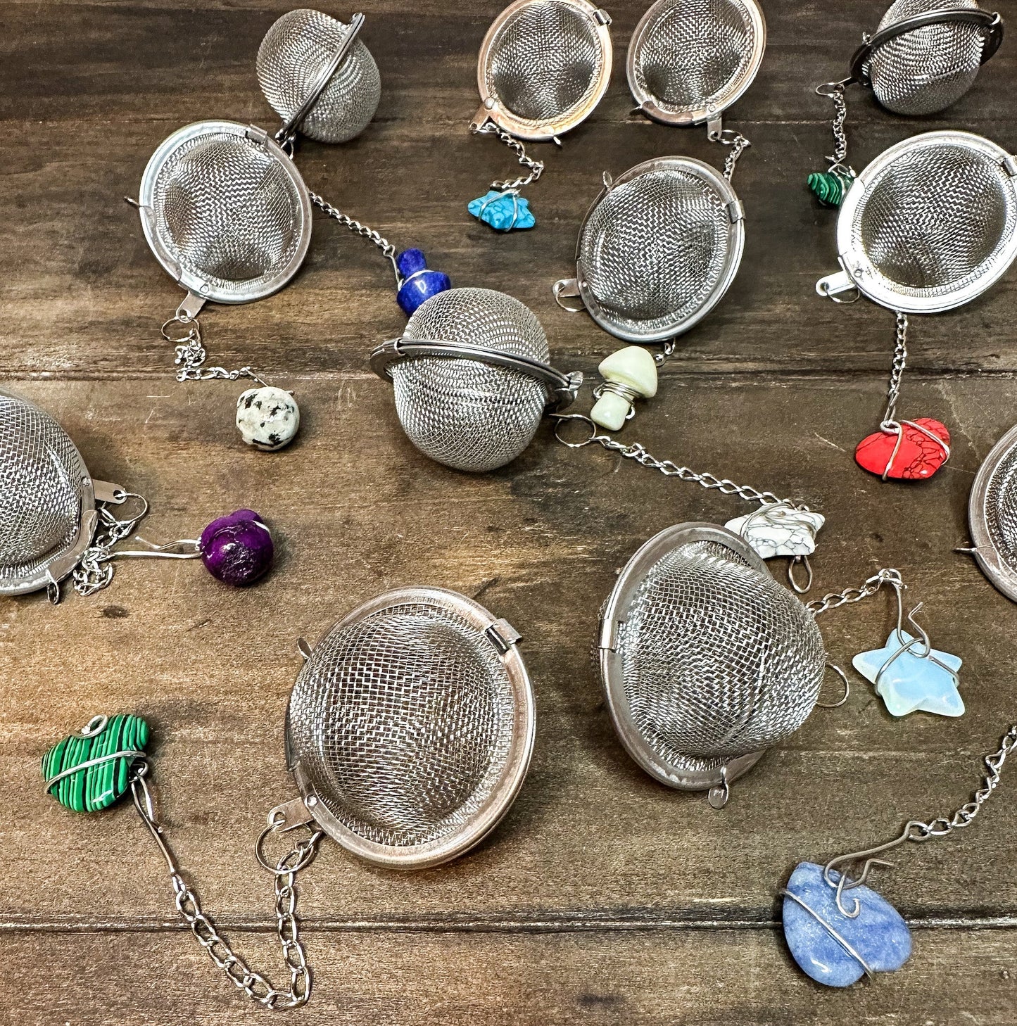 Herbalroseapothecary tea ball infuser with stainless steel mesh for steeping loose leaf teas in cups or teapots.