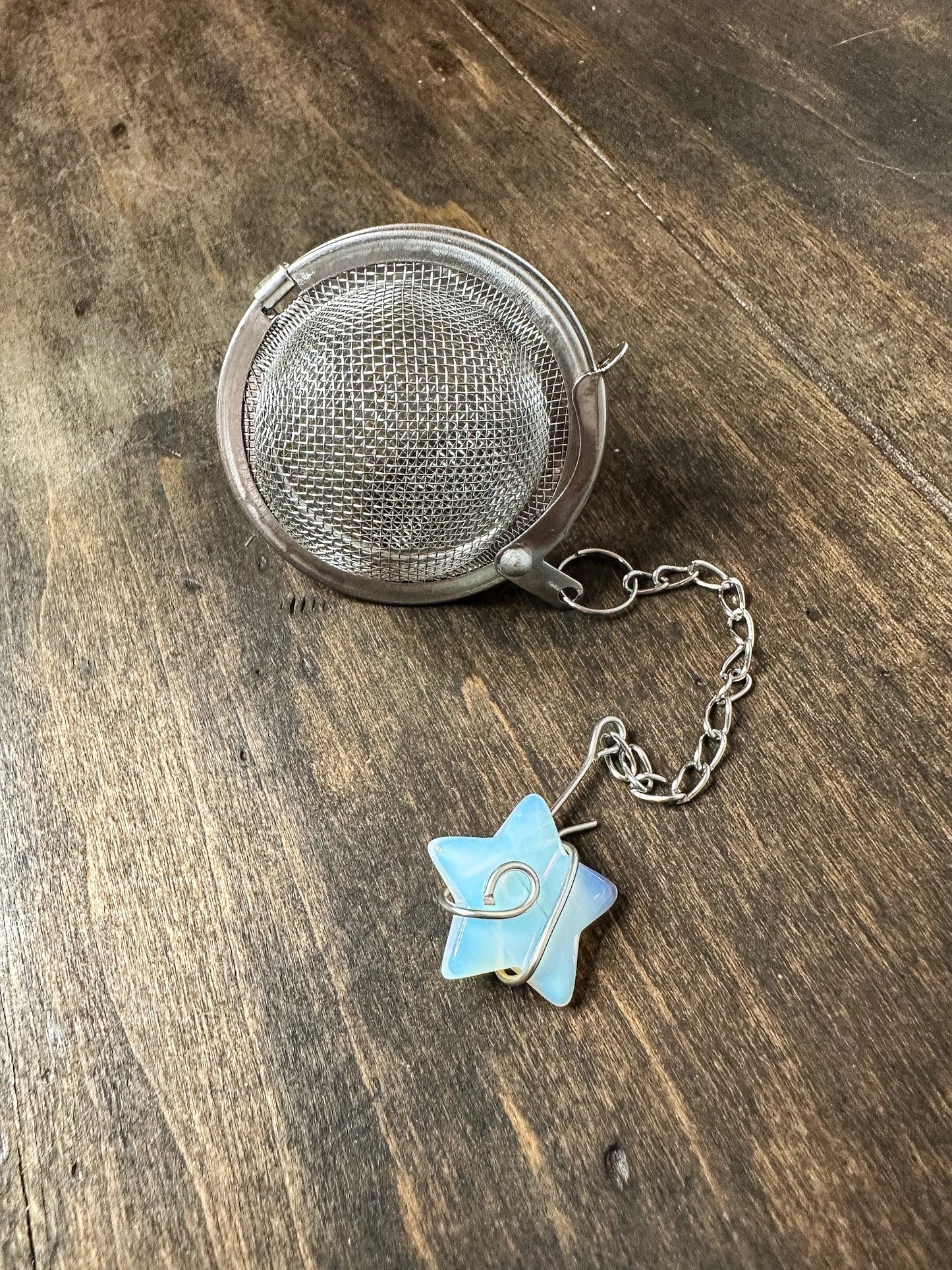 Herbalroseapothecary tea ball infuser with stainless steel mesh for steeping loose leaf tea in a cup or teapot