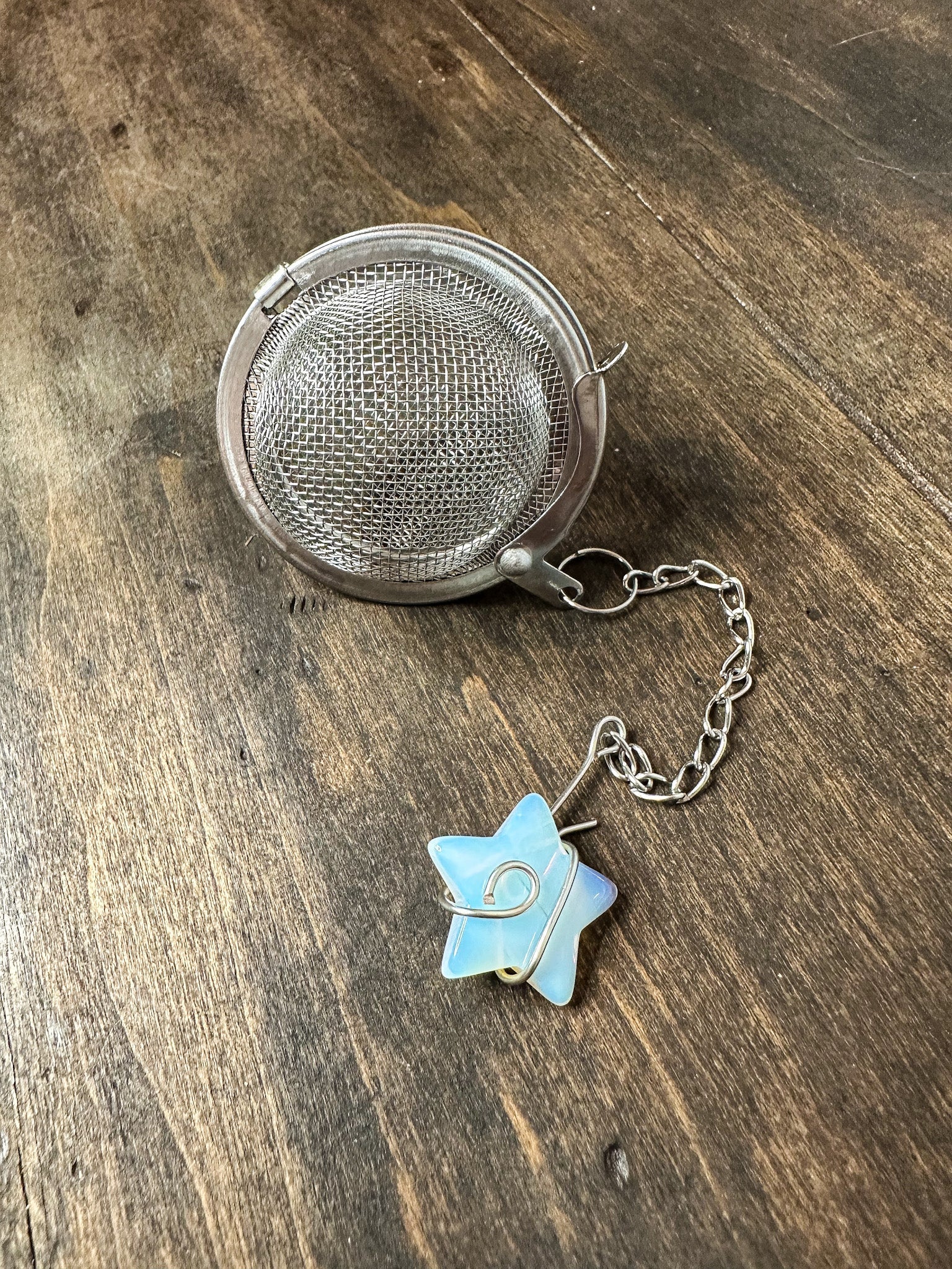 Herbalroseapothecary tea ball infuser with stainless steel mesh for steeping loose leaf tea in a cup or teapot