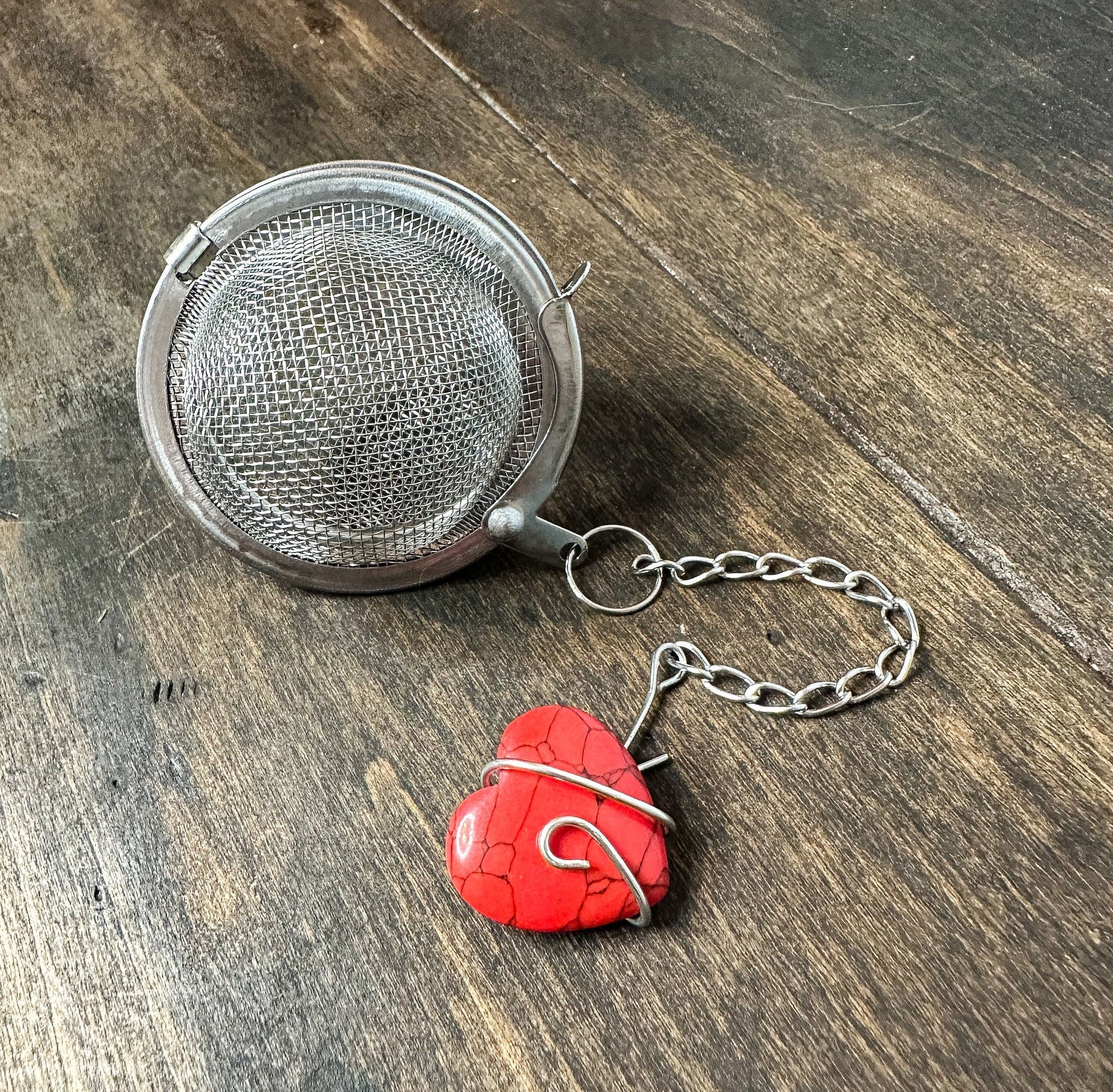 Herbalroseapothecary tea ball infuser, stainless steel mesh tea strainer for loose leaf tea brewing, round and compact design.