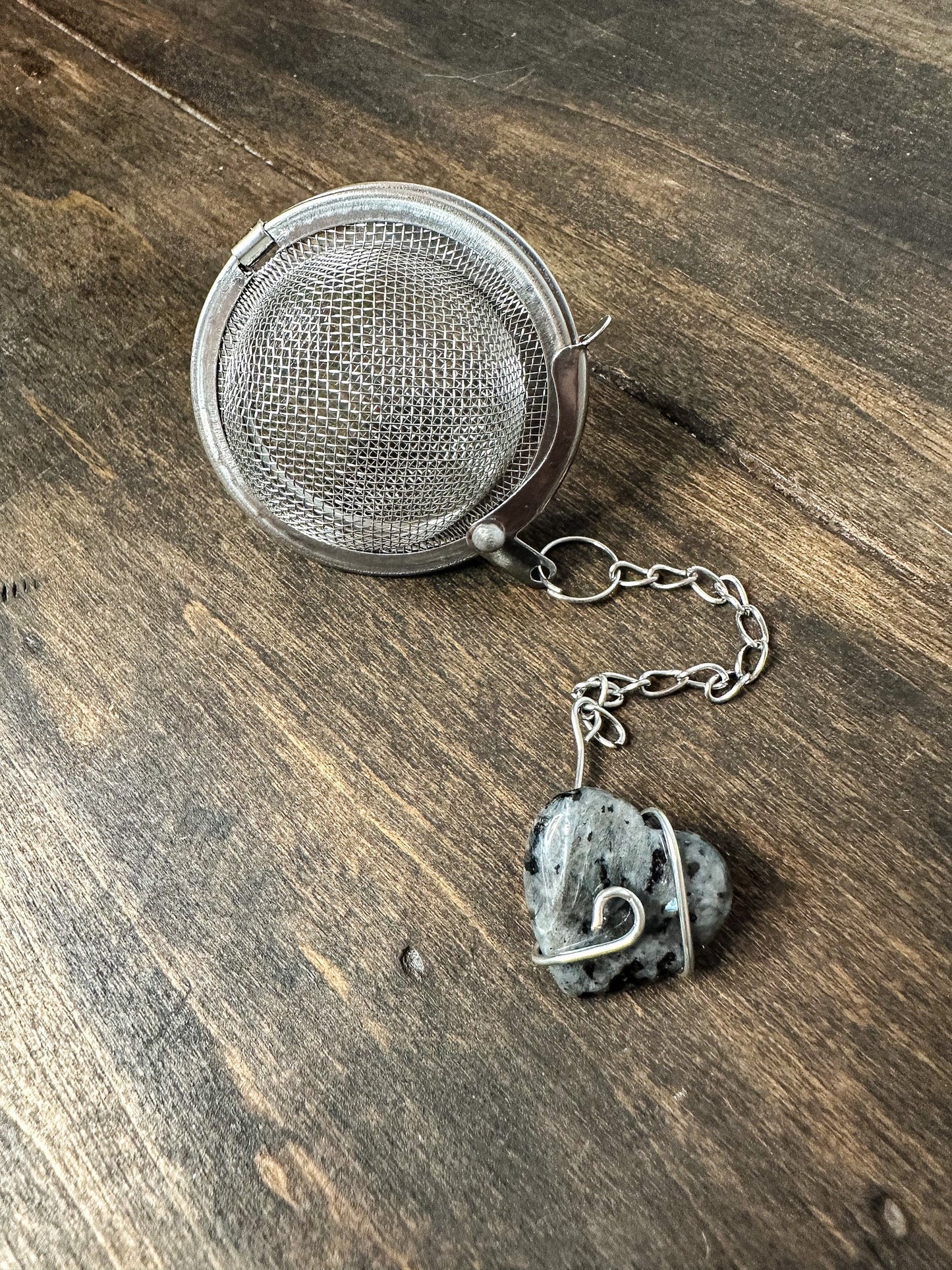 HerbalRoseApothecary tea ball infuser with stainless steel mesh for loose leaf tea brewing.
