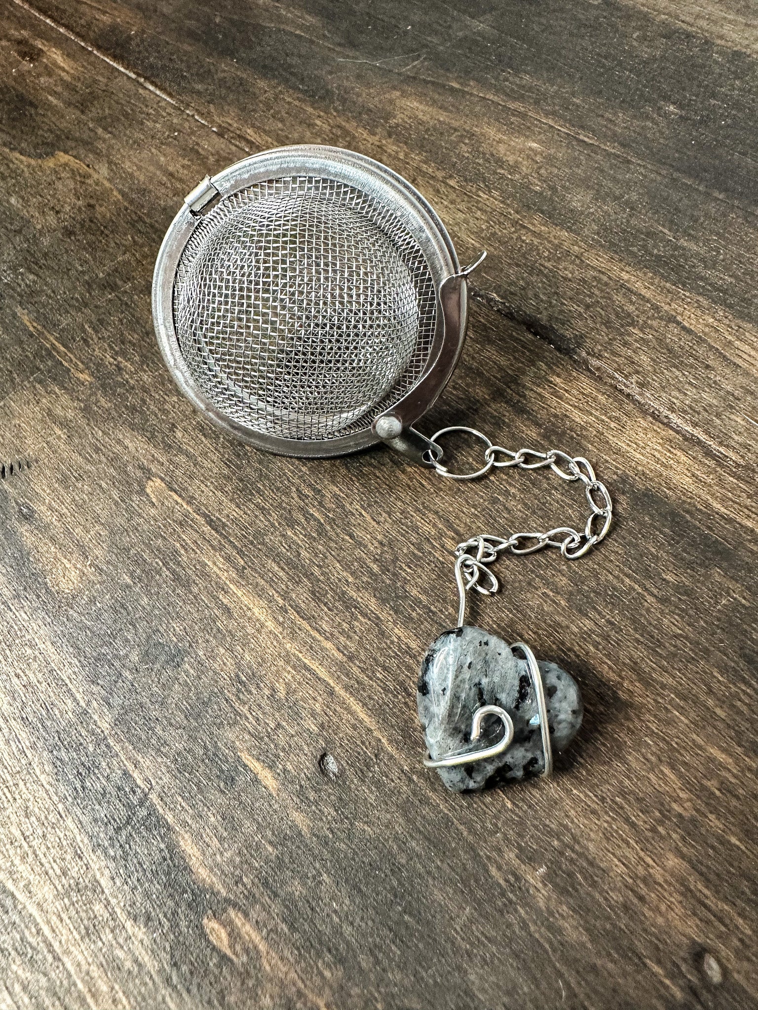 HerbalRoseApothecary tea ball infuser with stainless steel mesh for loose leaf tea brewing.