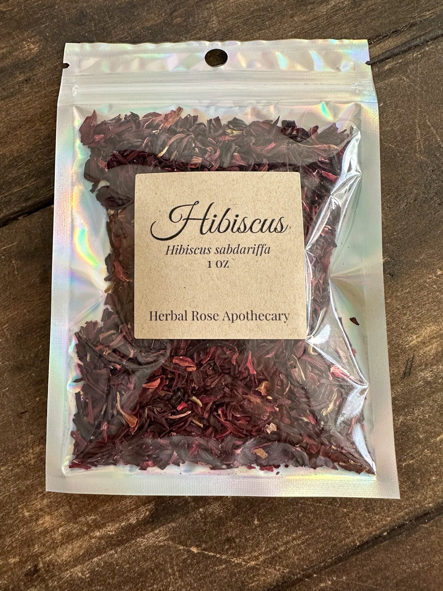 Dried hibiscus herb in a 1oz package, showcasing vibrant red dried petals from HerbalRose Apothecary.