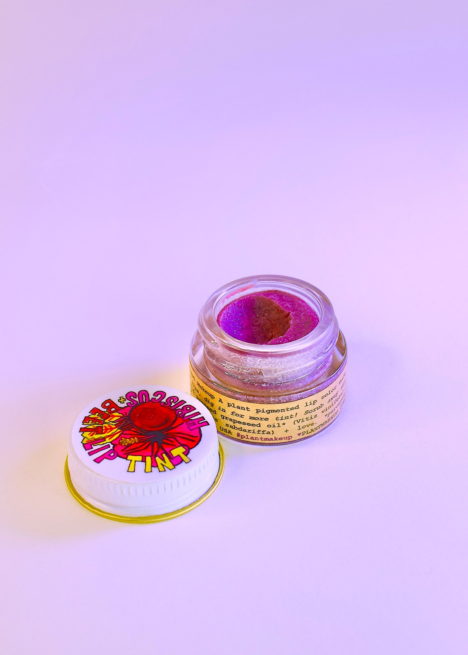 Plant Makeup Hibiscus and Beet Lip Tint applied on lips, showcasing vibrant natural color and smooth texture.