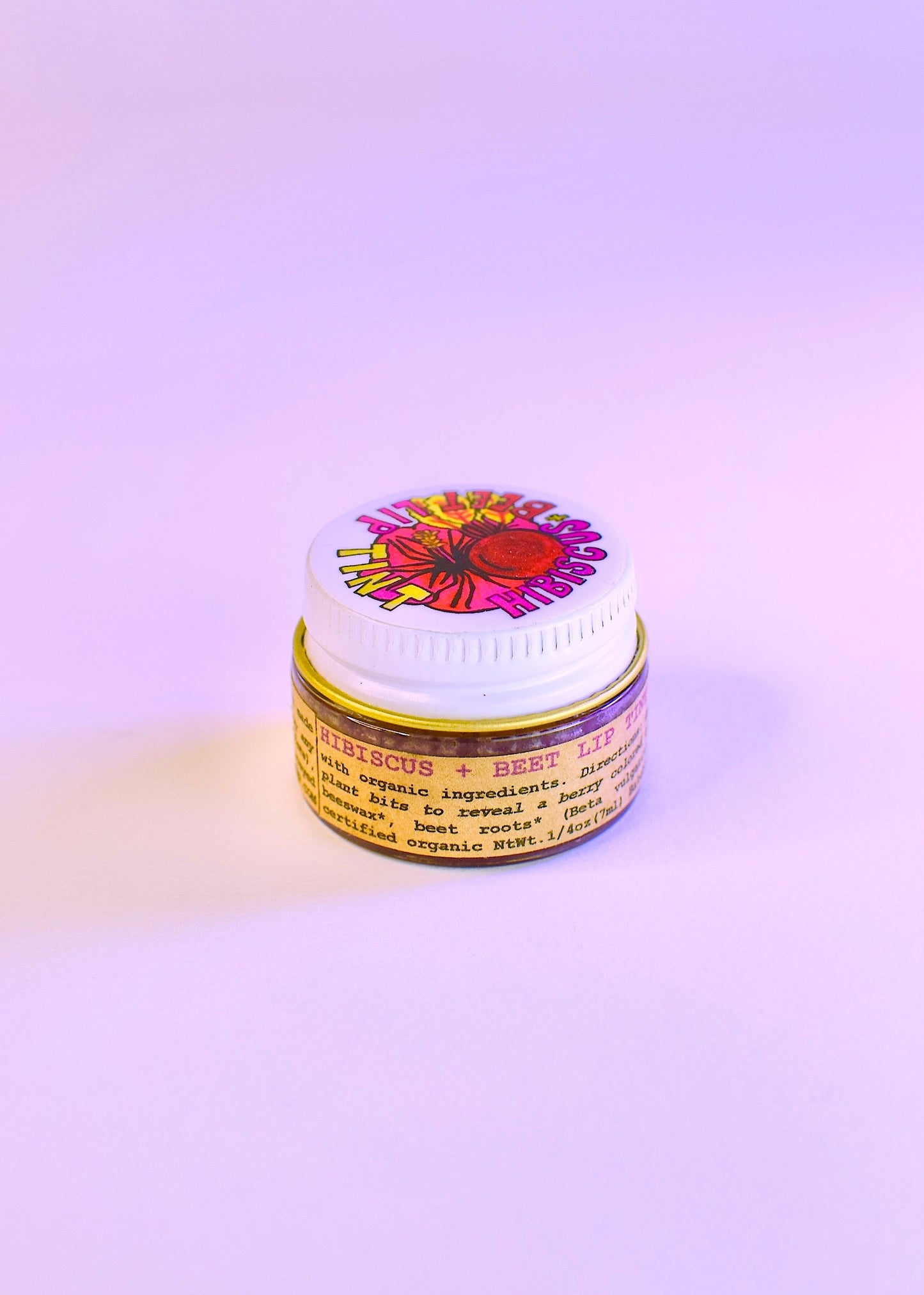 Plant Makeup Hibiscus and Beet Lip Tint tube with the tinted product visible on the lip area. Natural, vibrant lip color.