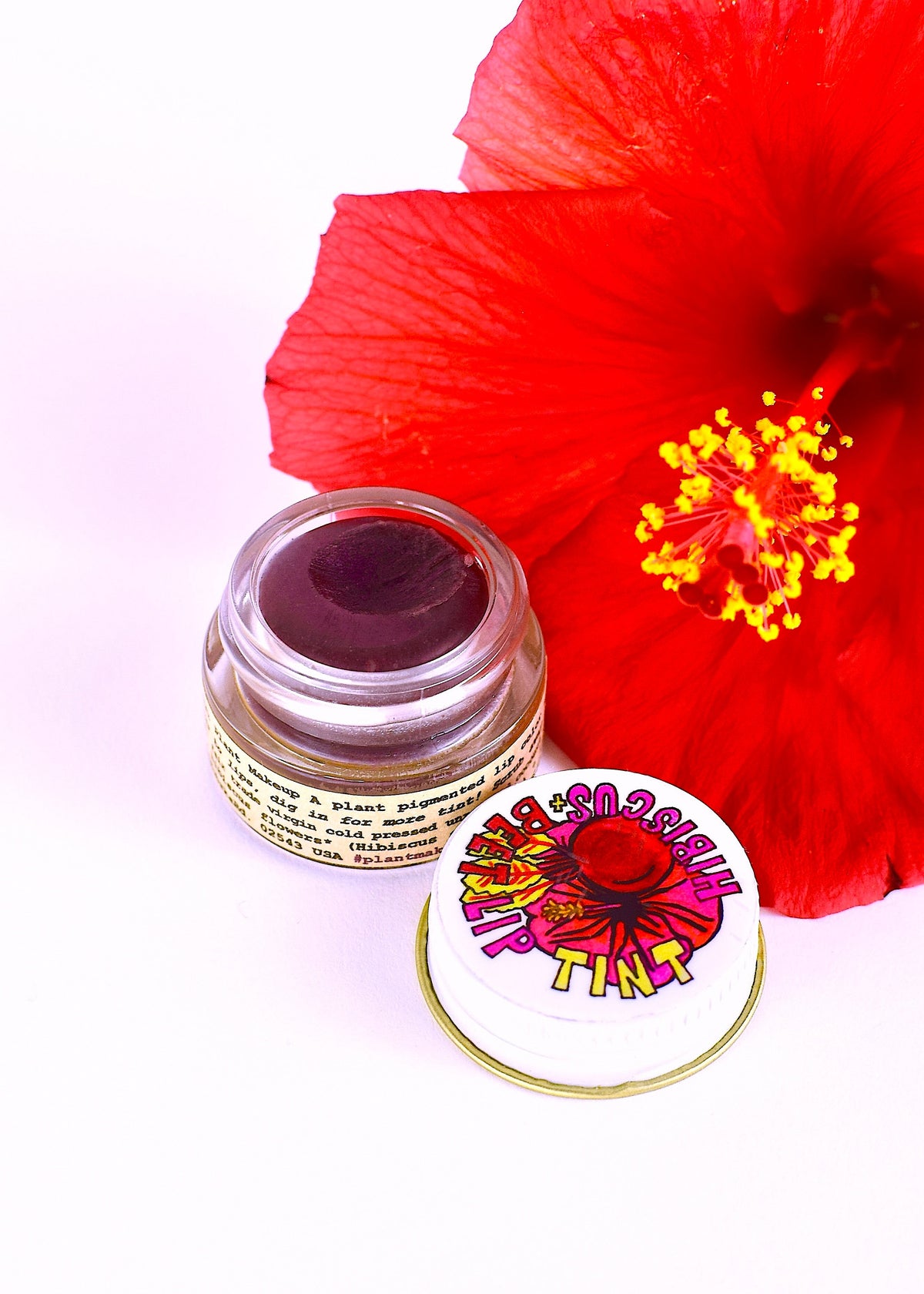 Plant Makeup Hibiscus and Beet Lip Tint applied on lips, showcasing vibrant natural color and smooth texture.