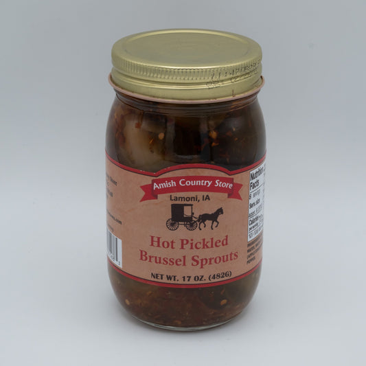 Canned Amish Country Store hot pickled Brussels sprouts in a jar, showing bright green sprouts submerged in spicy brine.