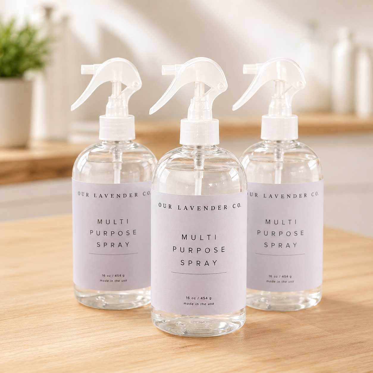 Lavender multipurpose cleaning spray by Our Lavender Co, shown in various sizes, with spray nozzle and lavender scent label.