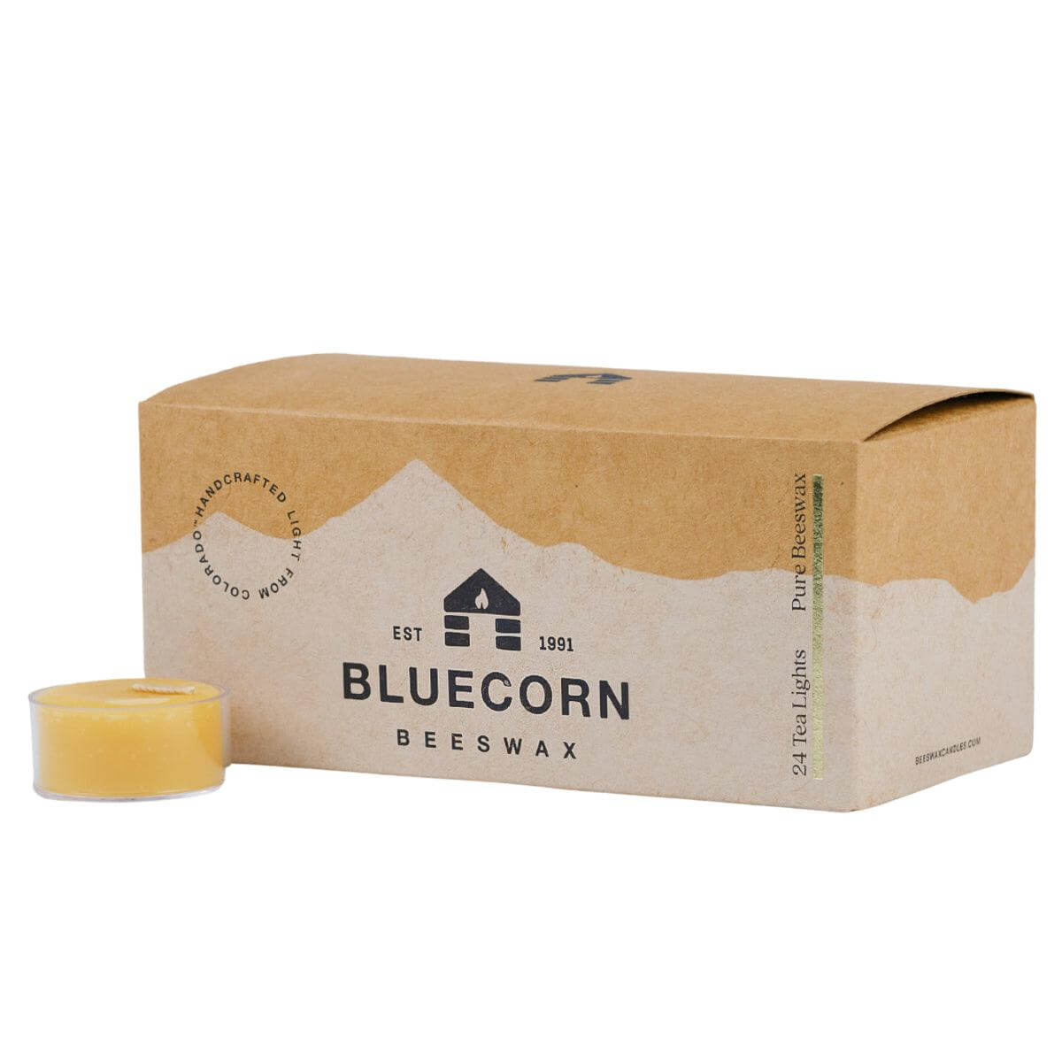 Pure beeswax tea light candles from Bluecorn Candles, showing several small, natural beeswax tea lights arranged on a surface.