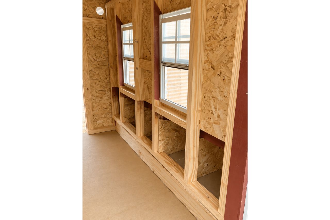Inside the OverEZ large chicken coop with space for up to 15 chickens, showing roosts, nesting boxes, and chickens inside.