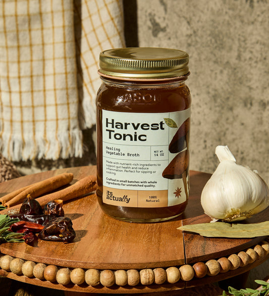 Three 14oz jars of Its Actually Co. Healing Vegetable Broth beverage showing clear glass jars with vegetable broth inside.