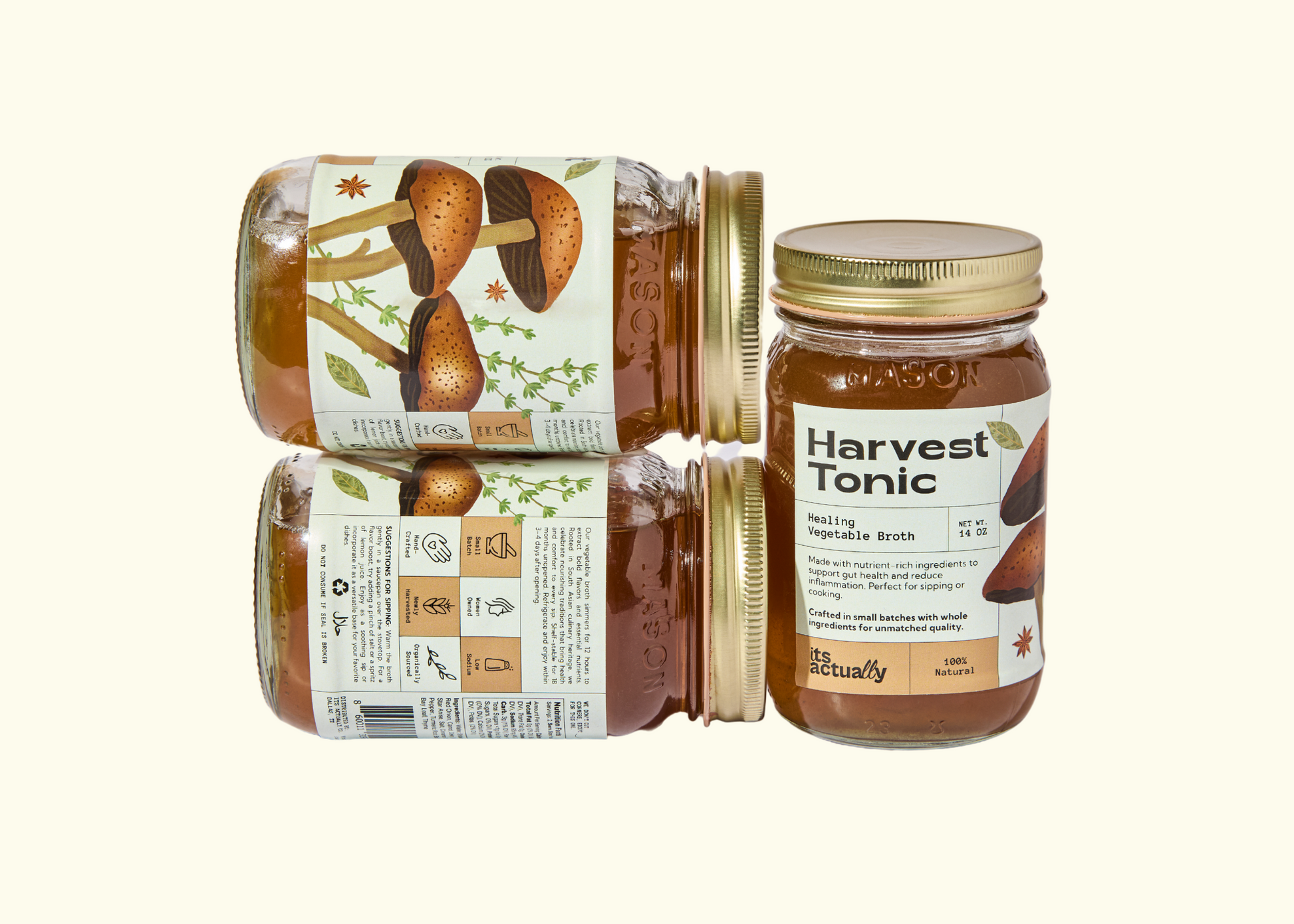 Three 14oz jars of Its Actually Co. Healing Vegetable Broth beverage, featuring fresh vegetable ingredients in clear glass jars.