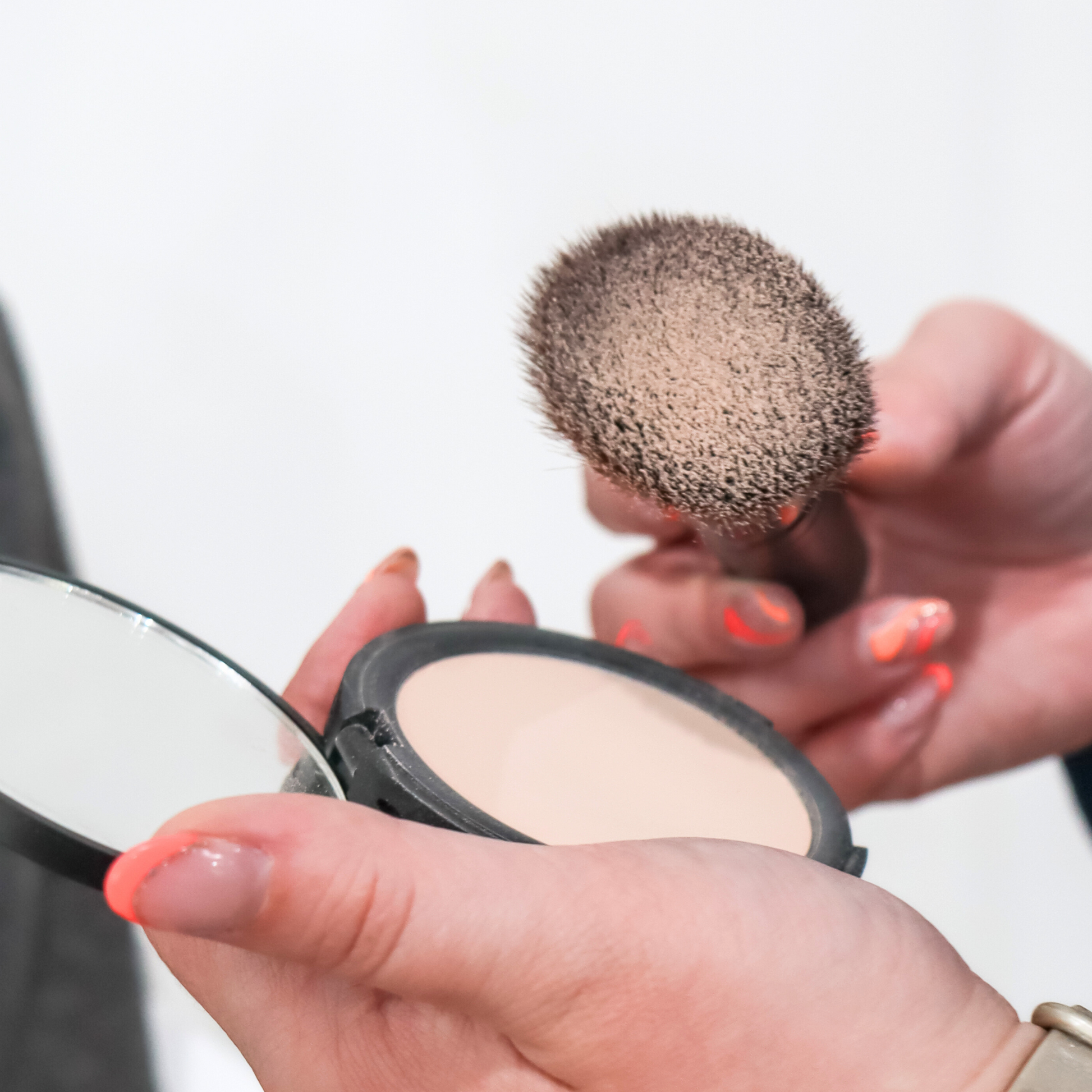 Taylor Made Organics pressed setting powder with jumbo flat brush for a smooth, matte finish on the face.