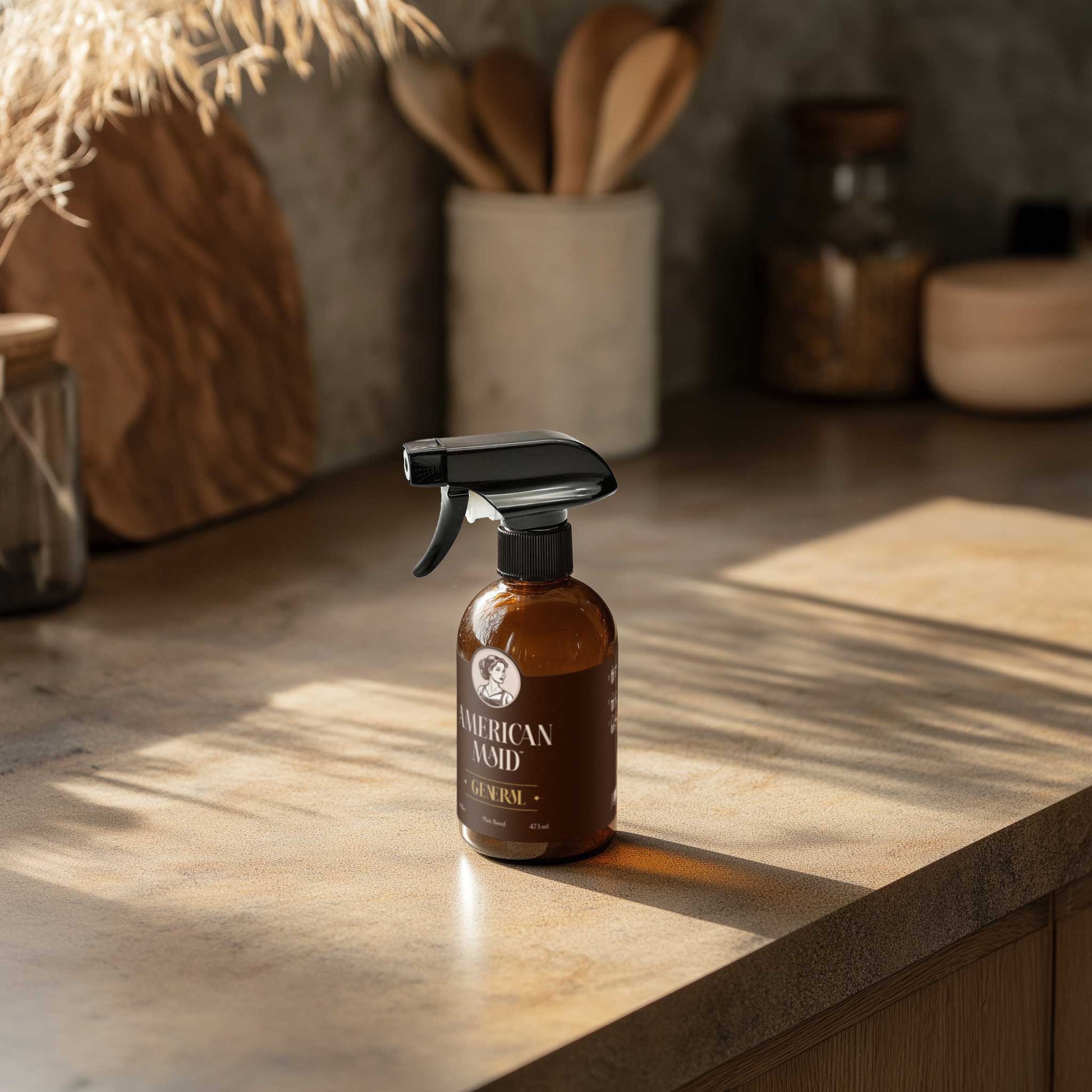 American Maid Daily Essentials Kit in a kitchen setting, including cleaning supplies and tools for daily household use.