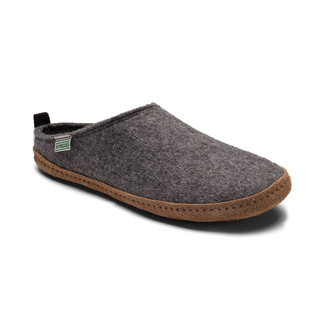 The Kyrgies Indoor Wool Slides by Kyrgies feature a single grey handcrafted wool slipper with a brown sole and side fabric tag, shown on a white background—offering natural, biodegradable comfort and sustainable style in every step.