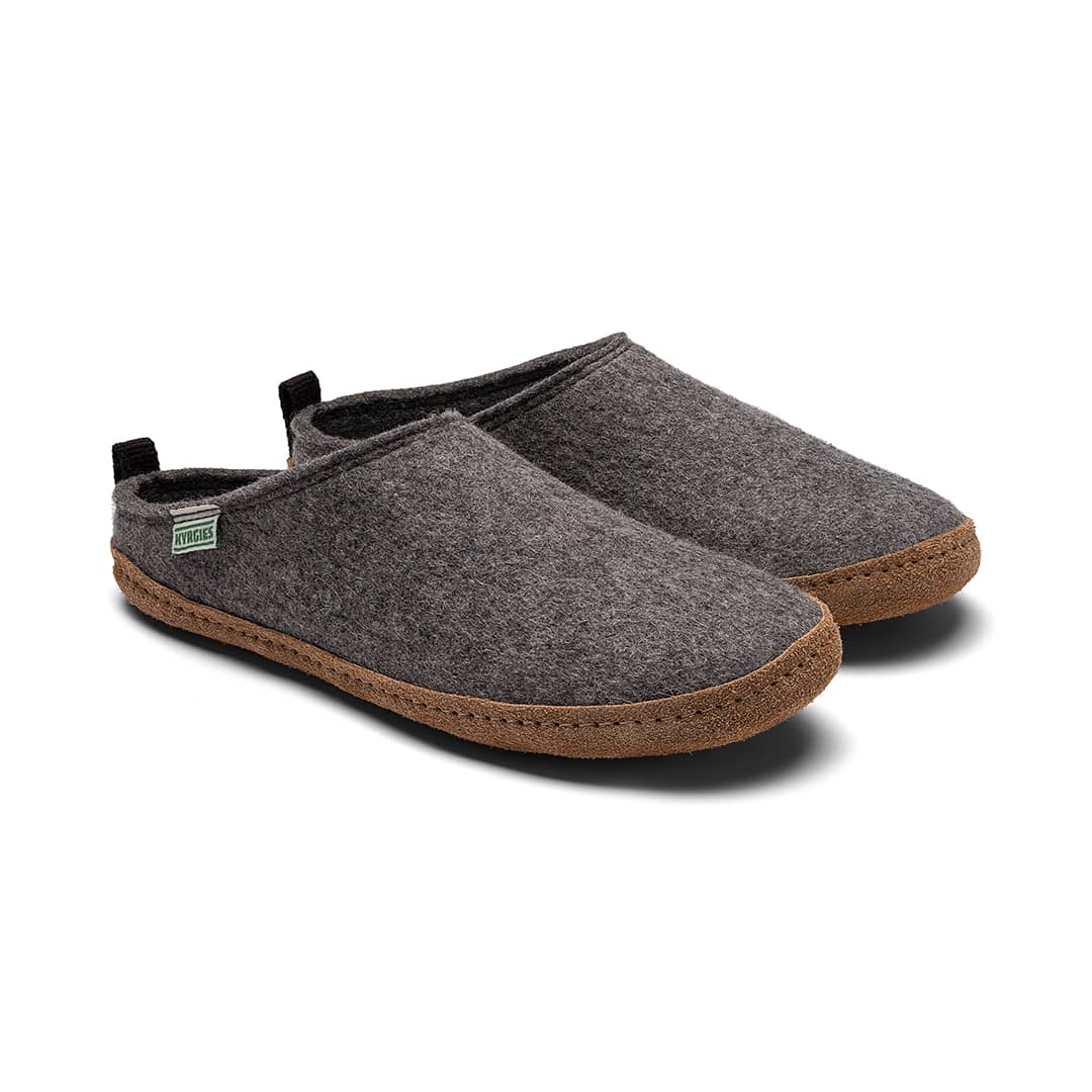 Kyrgies Indoor Wool Slides by Kyrgies are shown in gray felt with brown rubber soles and side fabric tags. These handcrafted, natural wool slippers offer comfort and sustainability, making them the perfect eco-friendly indoor footwear.