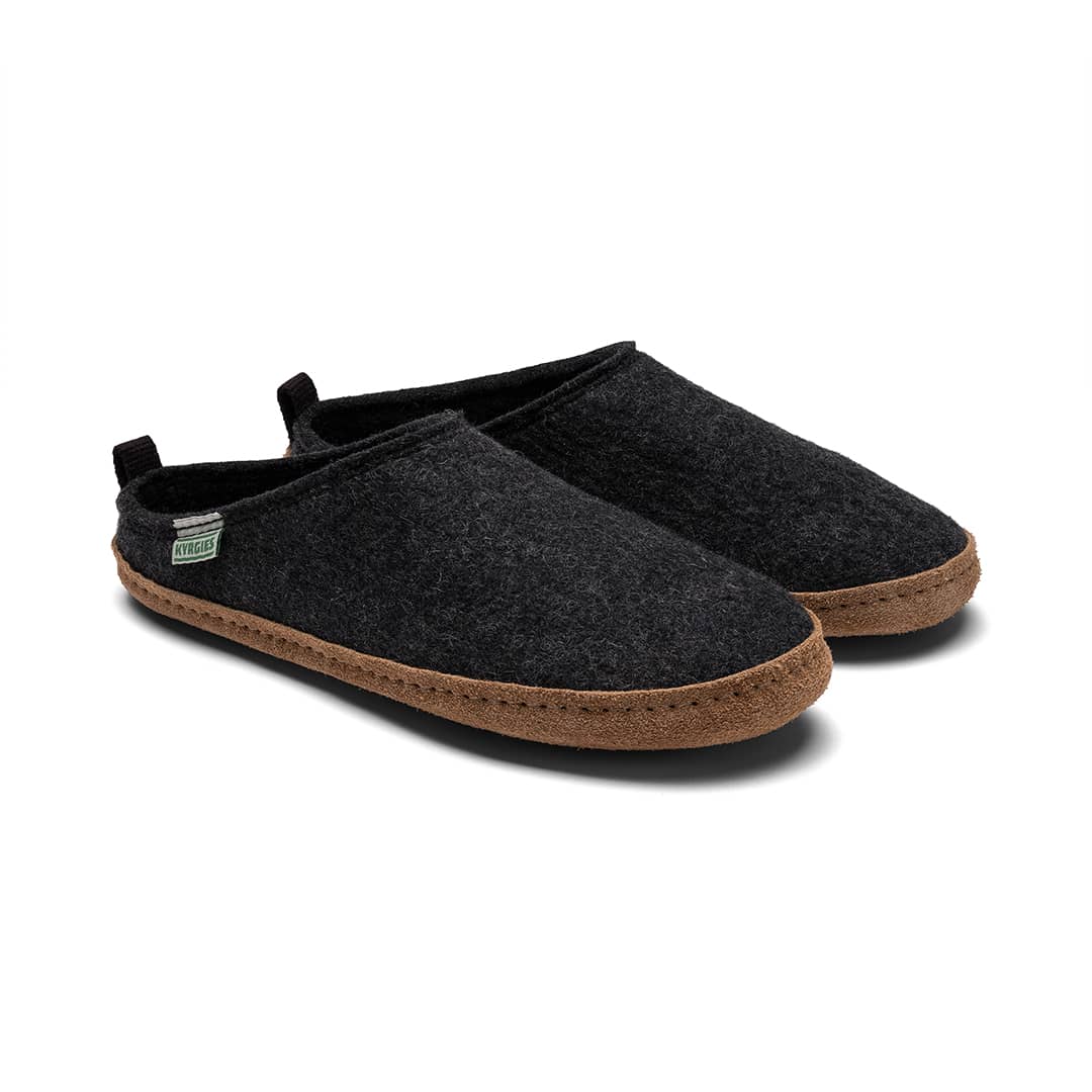 A pair of Kyrgies Indoor Wool Slides by Kyrgies in dark gray with brown soles is shown on a white background. The slippers feature a simple design, low heel tab, and a small side tag.