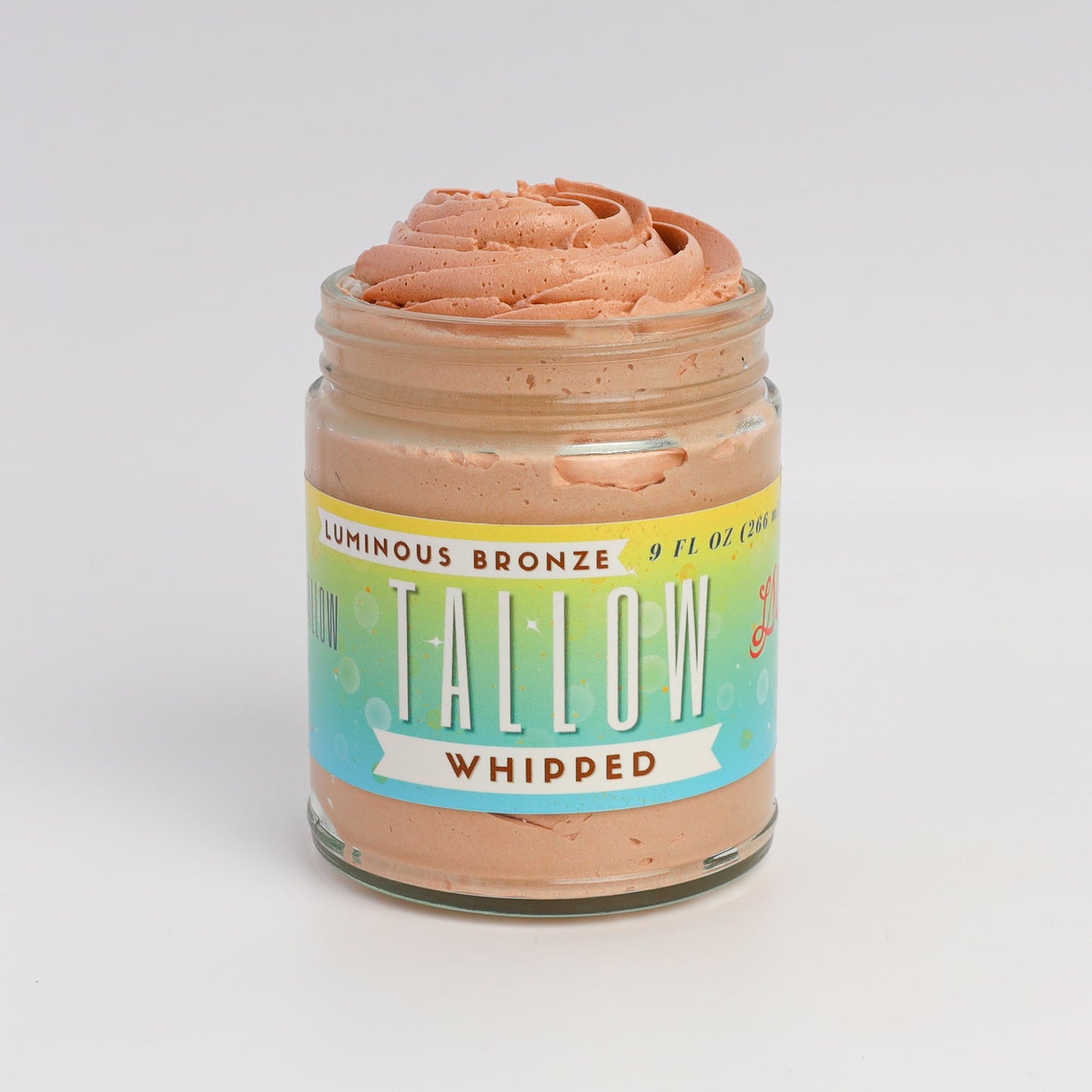 Lady May Tallow Luminous Bronze Whipped Tallow Moisturizer in 9 oz jar, showing smooth, bronze-tinted body cream with glossy texture.