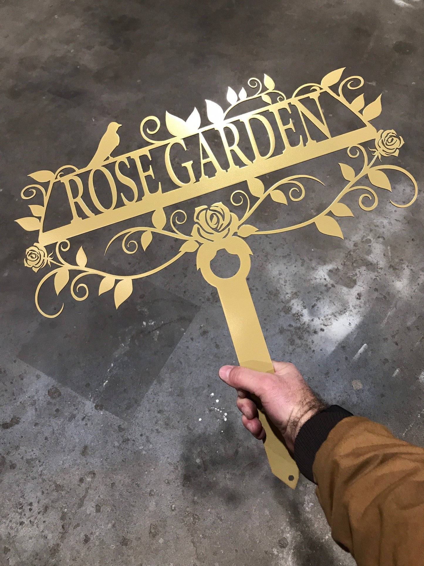 Black 20x20 custom garden sign by Lewis Design Company with "Rose Garden" text, outdoor patio and garden art.