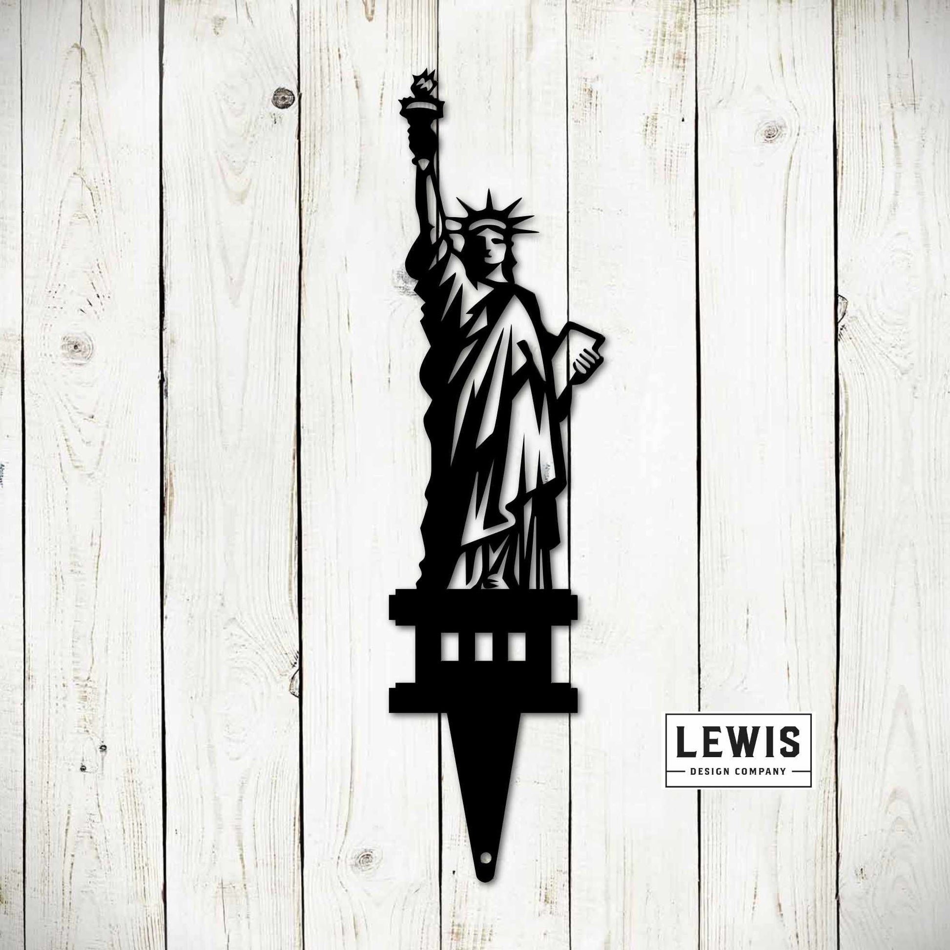 Black metal Statue of Liberty garden stake and yard art sign for outdoor patriotic decoration and 4th of July celebrations.