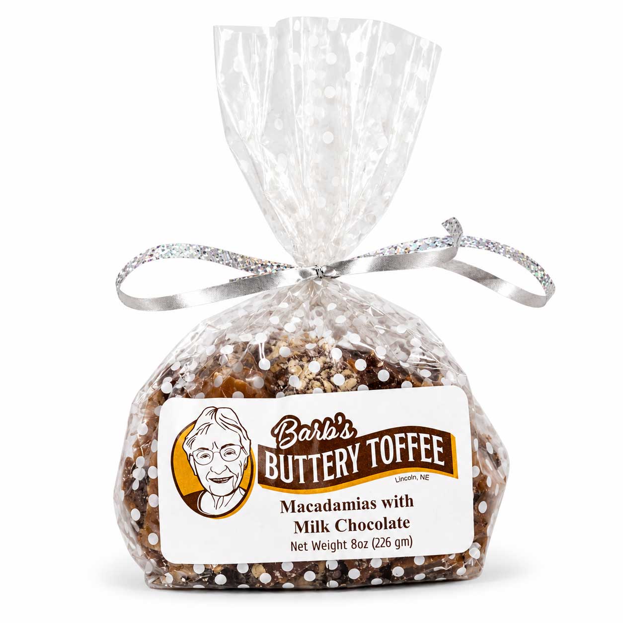 Homemade milk chocolate toffee with macadamia nuts from Barb's Buttery Toffee, 8 oz, featuring creamy chocolate and crunchy nuts.