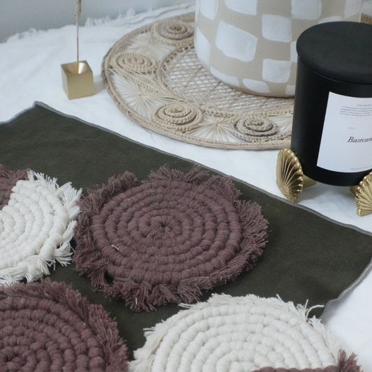 Set of four handmade macrame coasters by Tilley + Me, boho-style table decor with intricate knotted patterns for drink protection.