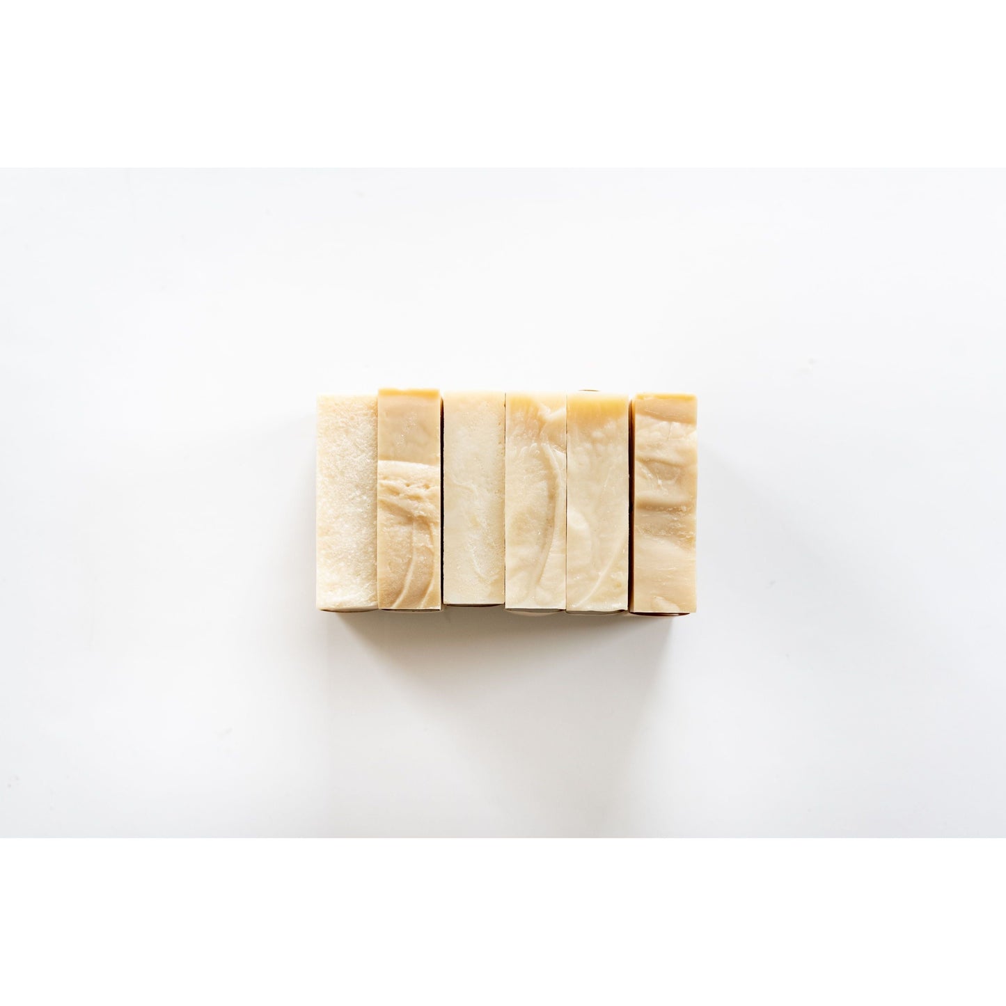 Five rectangular MamaSuds Pet Wash Bar Unscented vegan, biodegradable soaps arranged in a neat row on a white background, viewed from above.