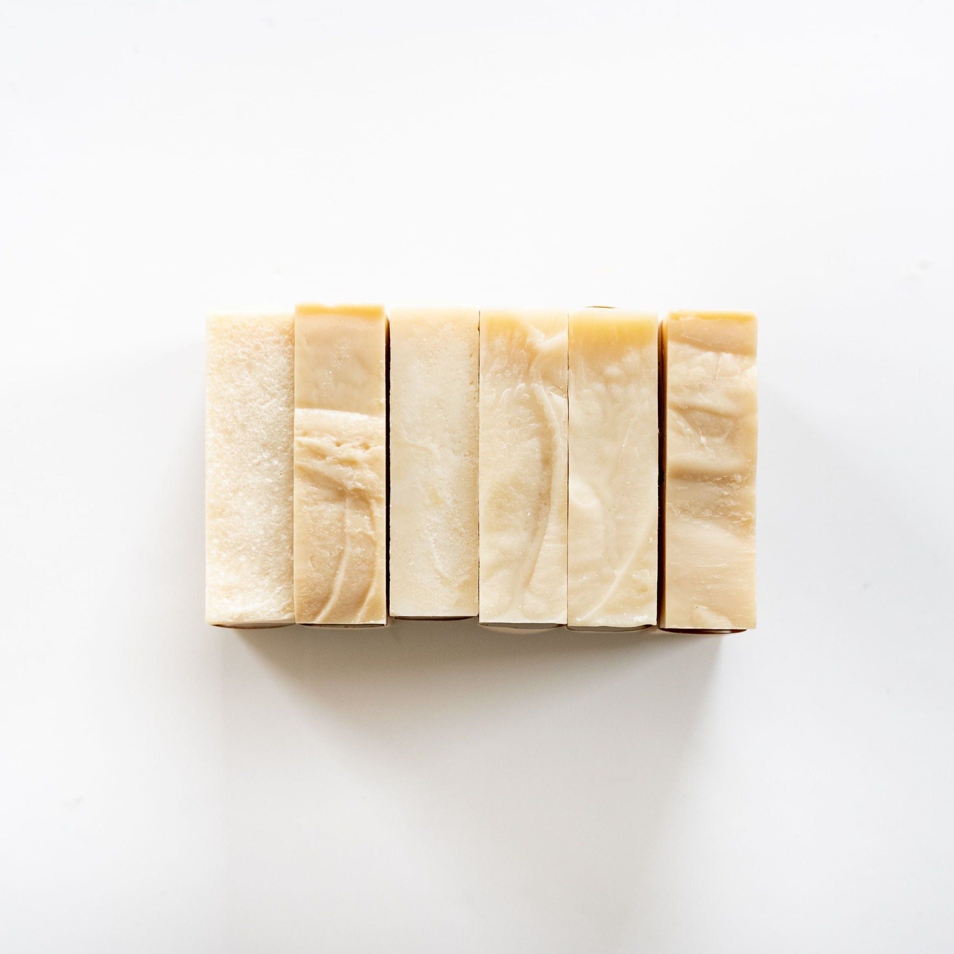 Six rectangular bars of MamaSuds Scented Castile Bar Soap, all-natural and biodegradable, are arranged vertically in a neat row on a white background.