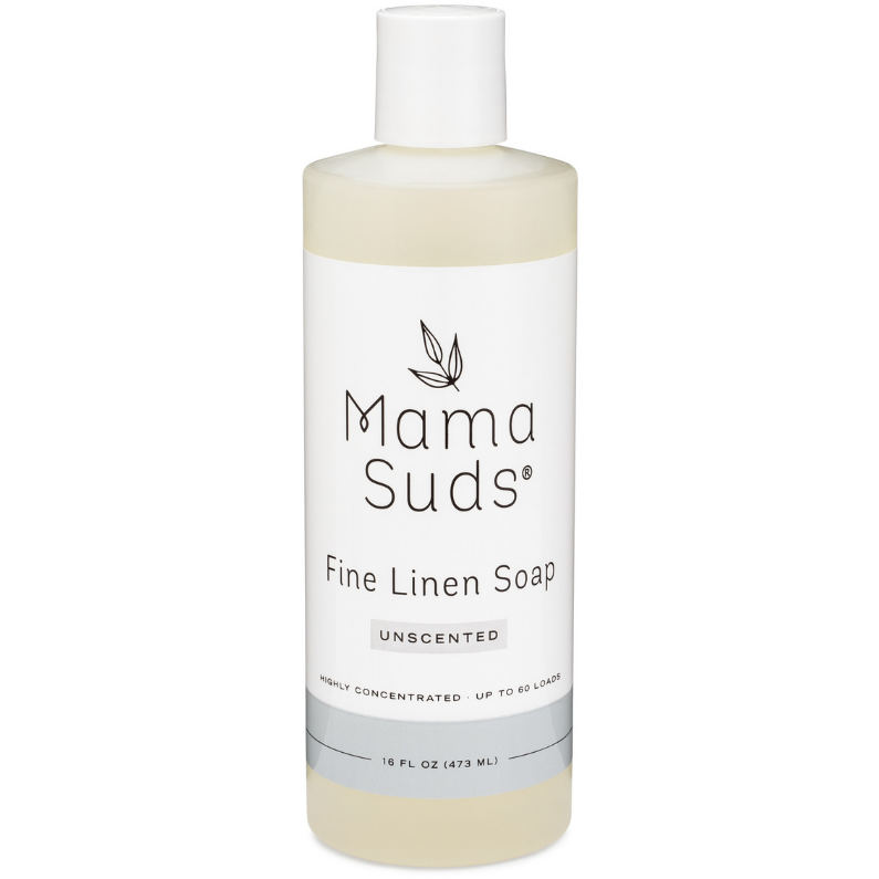 A 16 fl oz (473 mL) clear plastic bottle of MamaSuds Fine Linen Soap, unscented, with a white cap and minimal label design noting it’s highly concentrated and non-toxic.