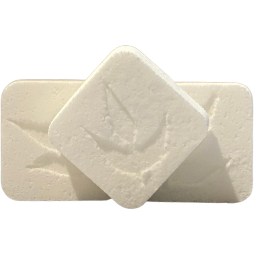Three MamaSuds Toilet Bomb Cleaning Tabs—two rectangular and one diamond-shaped, all white with a faint leaf imprint—rest on a plain background, showcasing this non-toxic toilet cleaner powered by natural citric acid.